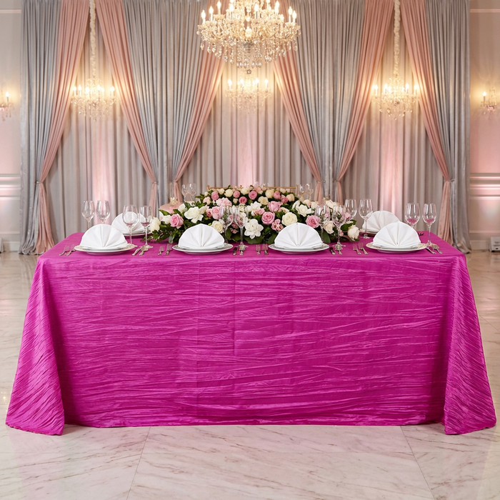 bridal table with the Accordion Crinkle Taffeta Rectangular Tablecloth Fuchsia with white napkins in a fan fold and a floral table runner