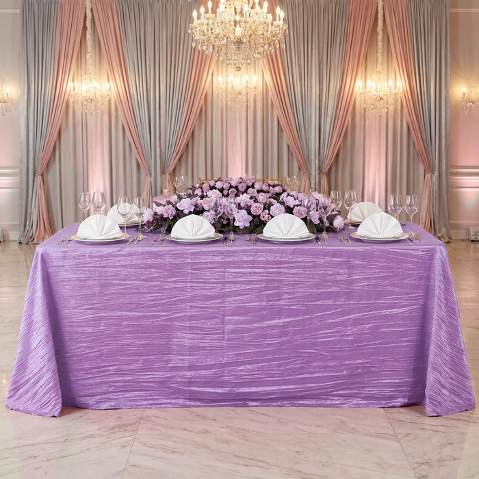 bridal table with the Accordion Crinkle Taffeta Rectangular Tablecloth Lavender over a 6ft rectangular table, lavender floral table runner and ivory napkins in a fan fold