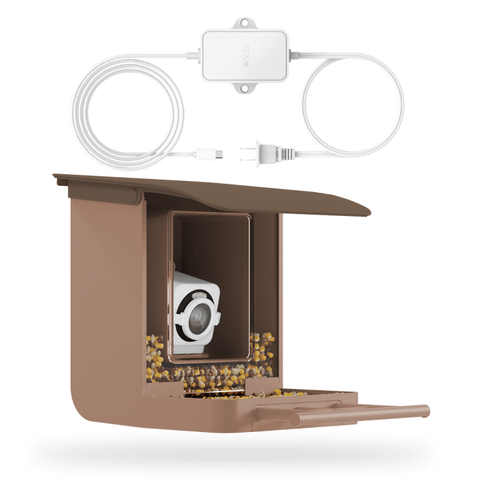 A bird feeder with a camera attached to it and a power adapter.