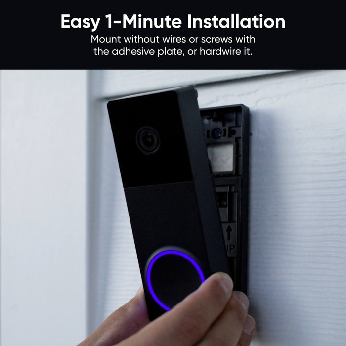 A person holding a doorbell with a dual camera view.