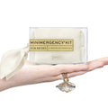 Bride holding ivory Minimergency Kit for Brides with wedding day essentials and perfume pendant