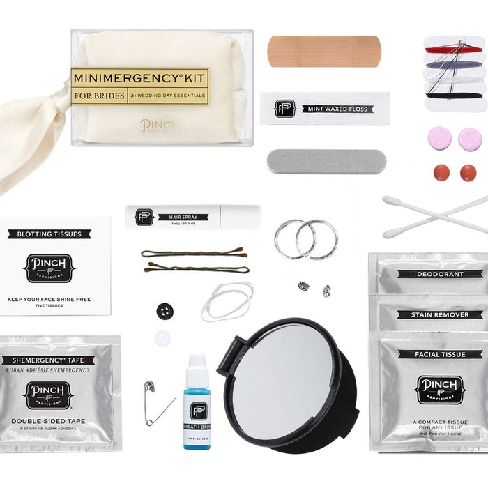 Pinch Provisions Minimergency Kit for Brides contents laid out showing 21 wedding day essentials