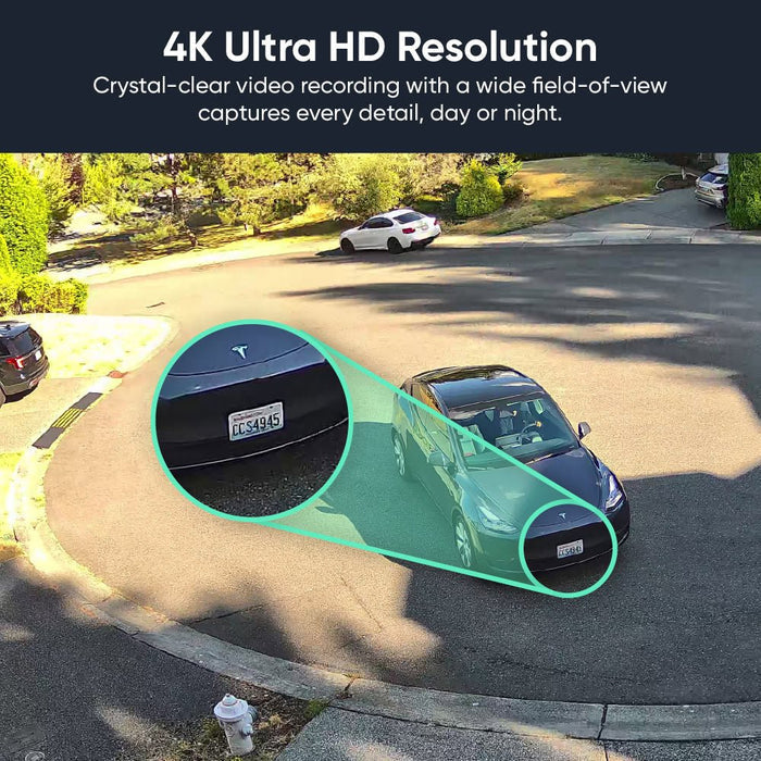 A black Tesla car parked in a driveway.