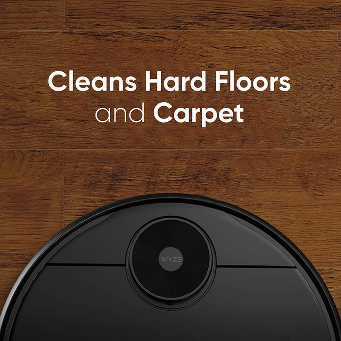 A black robot vacuum with a camera on the front.