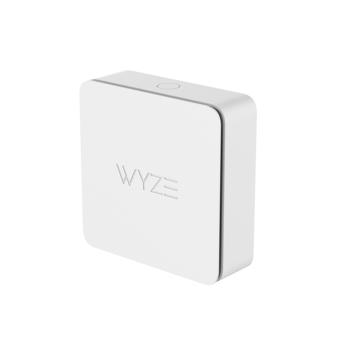 A white Wyze Sense Climate Sensor on a green background.