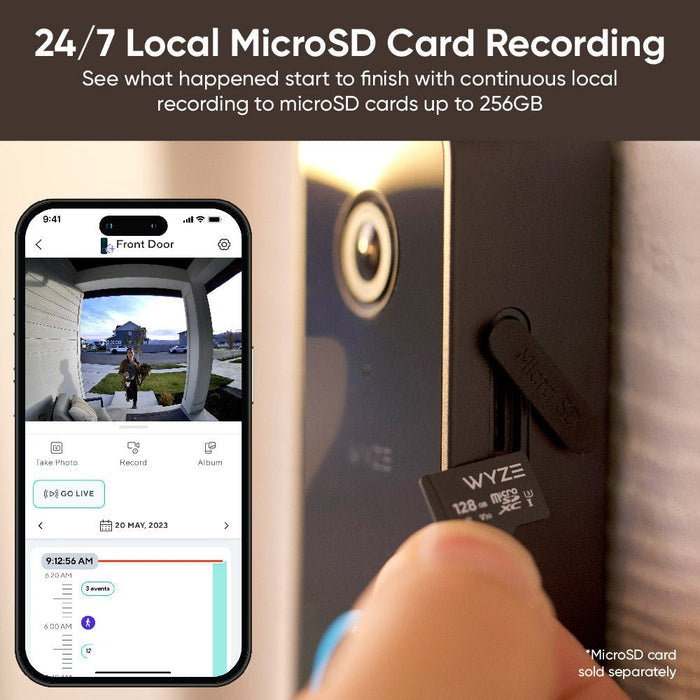 A person is holding a Wyze Video Doorbell v2.