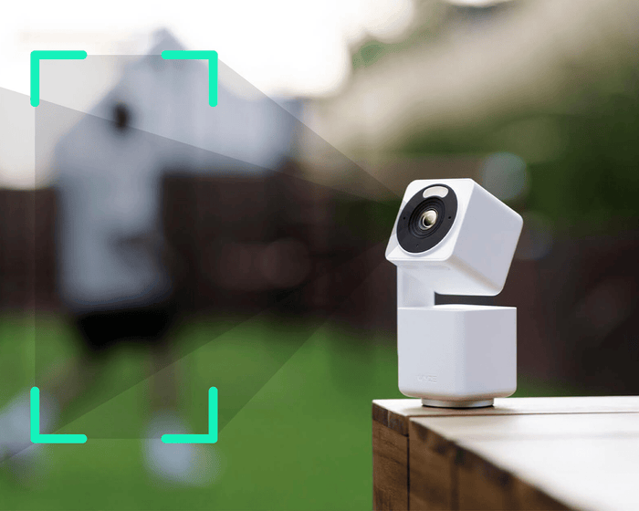 A white security camera kit with a green background.