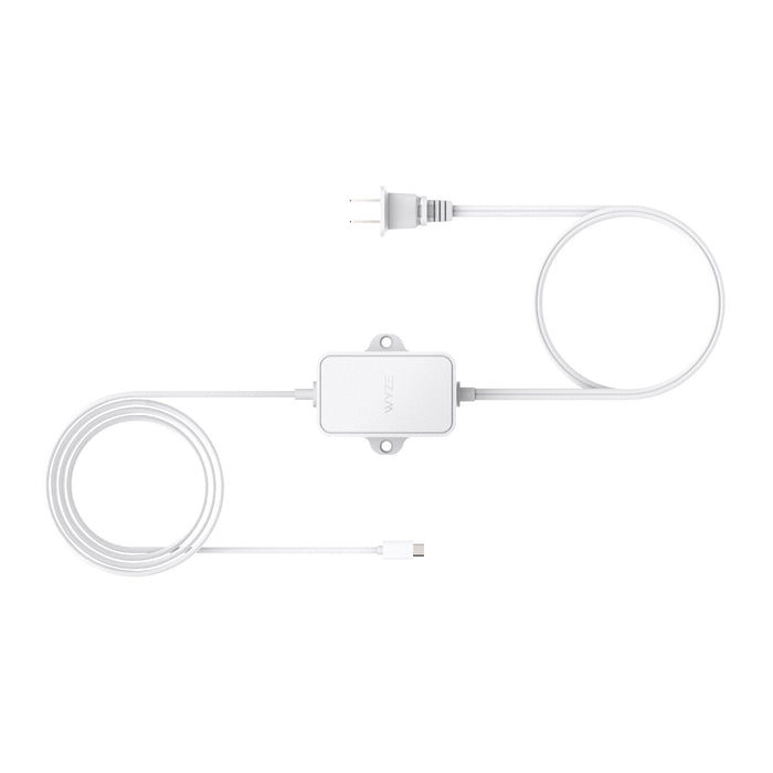 A white outdoor power adapter with a cord plugged into it.
