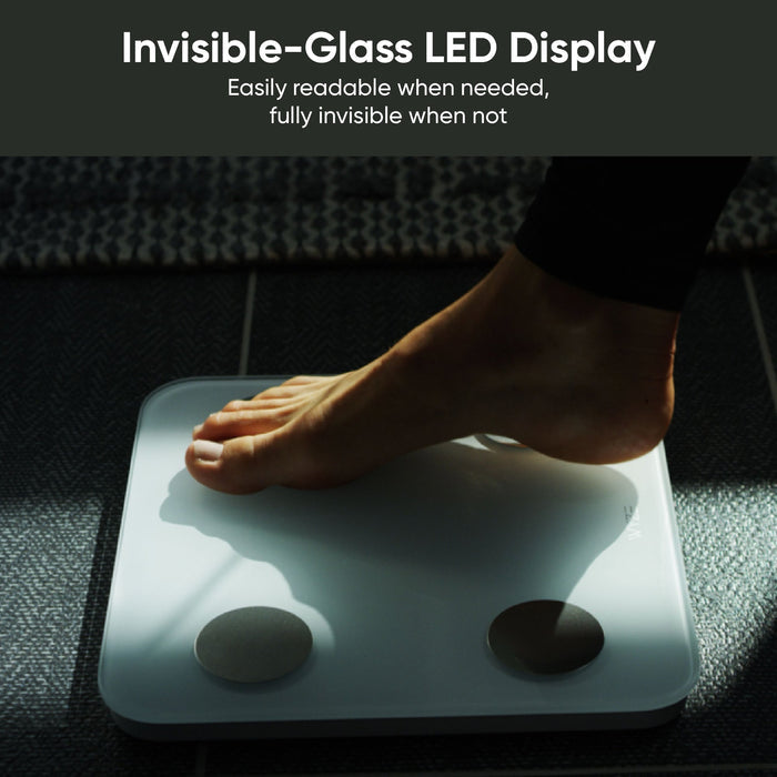 A person standing on a scale with their feet visible.