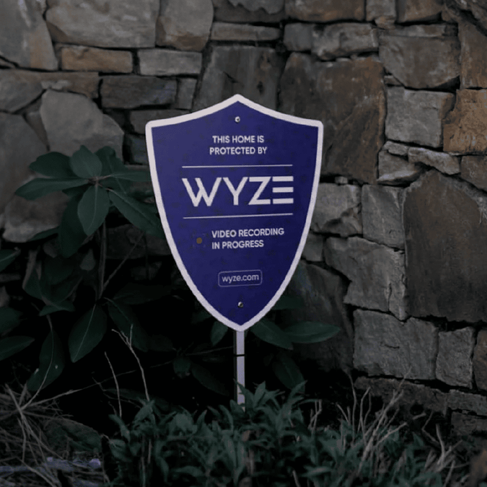 A purple sign with the words "Wyze Security" written on it.